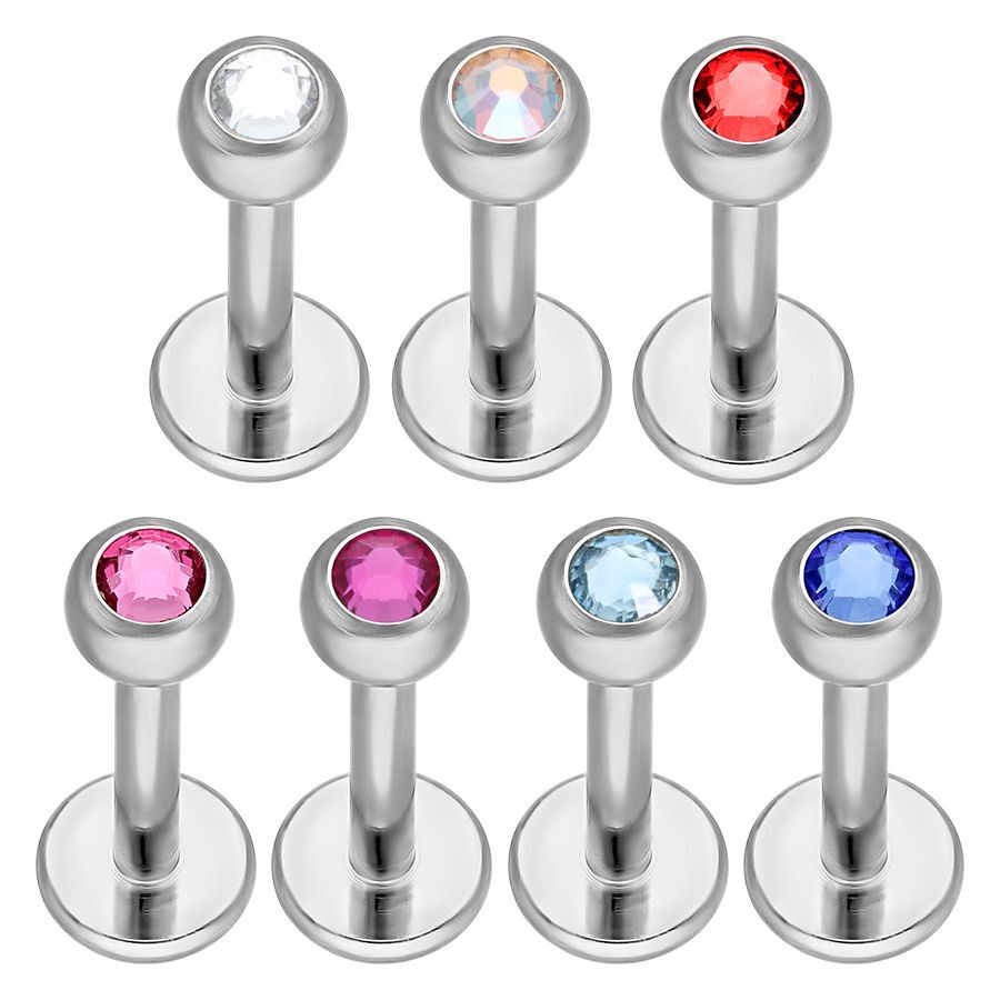 Titan Labret mit Kristallen, verschiedene Farben Silberne Titan-Labrets mit klaren, roten, rosa und blauen Kristallen auf weißem Hintergrund
